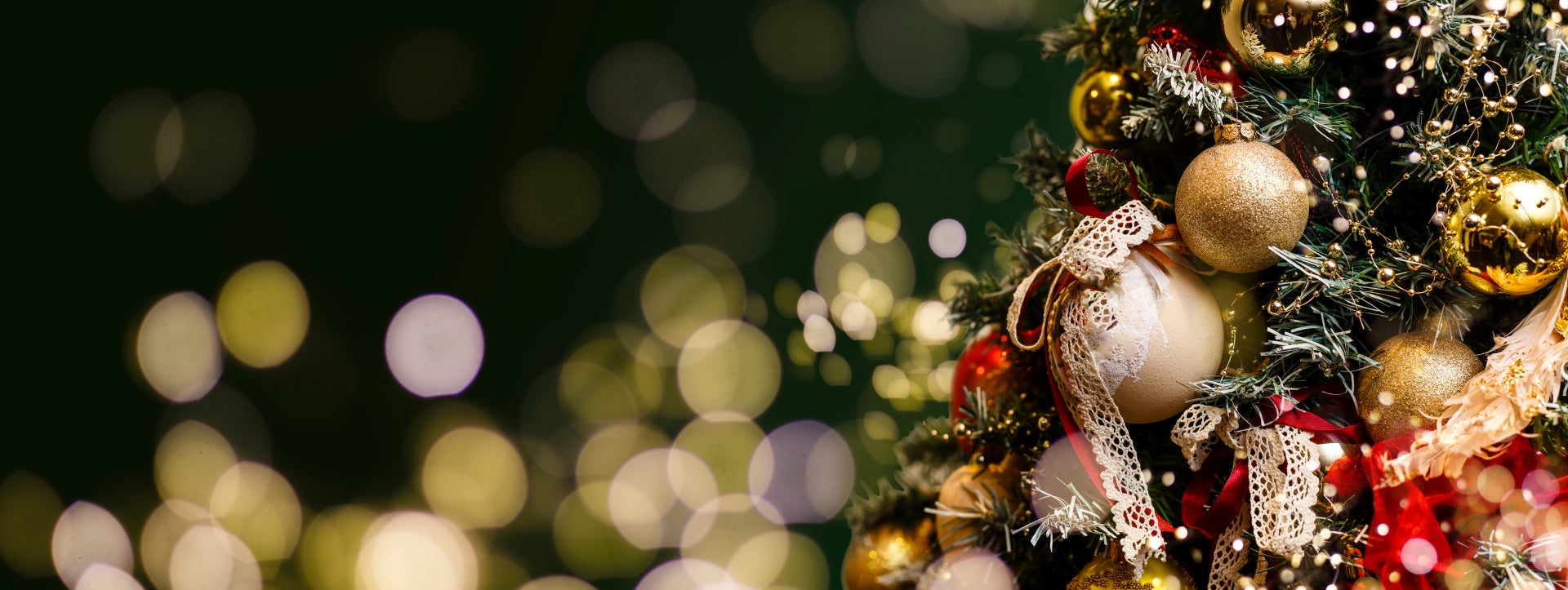 Decorative Christmas tree with ornaments and lights against a blurred festive background